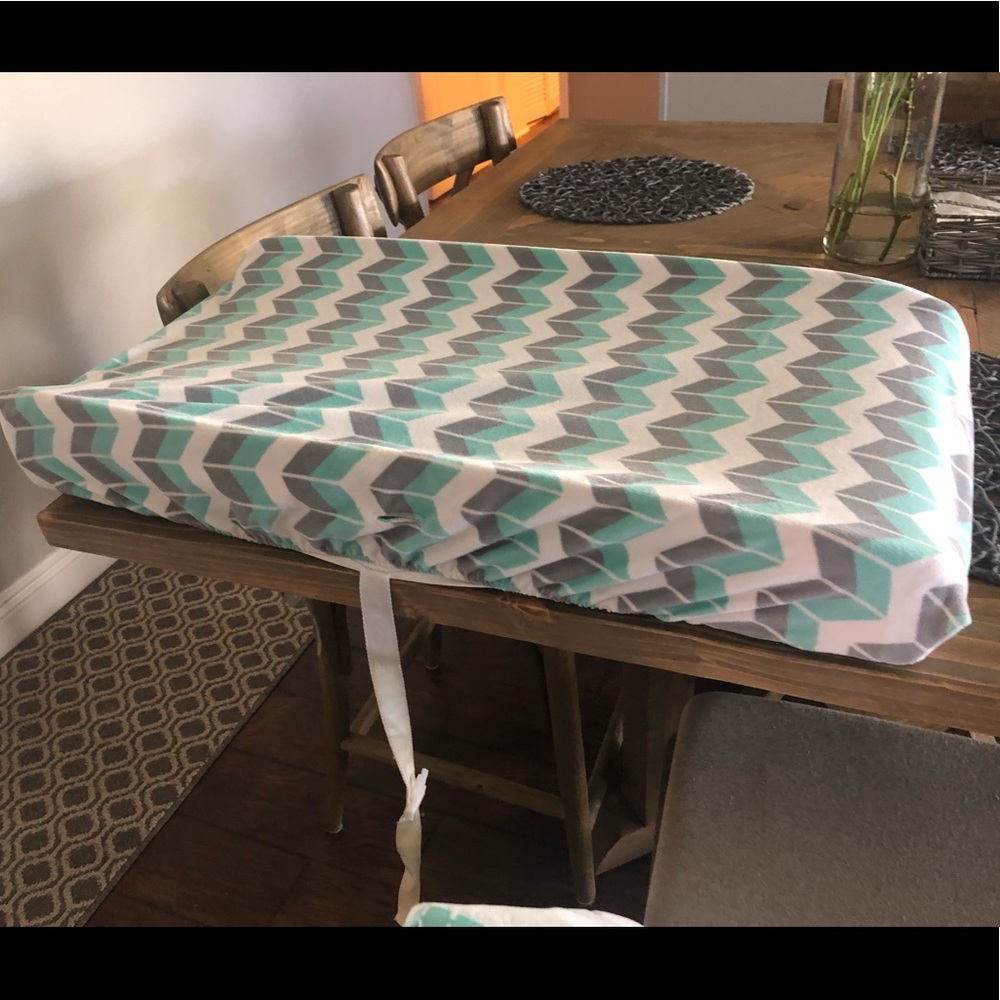 Changing pad with cover and crib skirt